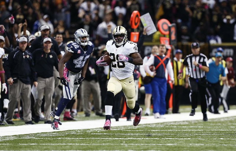 New Orleans running back C.J. Spiller (28) breaks free from Dallas defensive back Barry Church for the game-winning 80-yard touchdown in overtime to lift the Saints to a 26-20 victory.