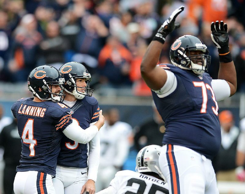 Chicago Bears kicker Robbie Gould (9) and holder Spencer Lanning (4) watch as Gould’s game-winning kick goes through the uprights Sunday against the Oakland Raiders in Chicago.