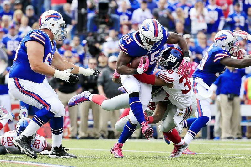 Buffalo Bills tight end Charles Clay (85) tries to break a tackle by New York Giants cornerback Trumaine McBride on Sunday in Orchard Park, N.Y. Clay (Little Rock Central) caught 9 passes for 111 yards.




