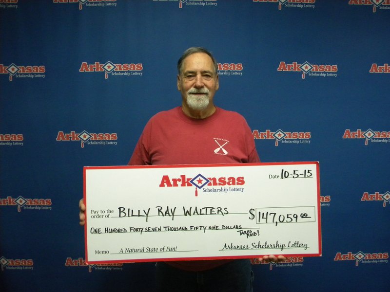 Billy Walters of Pine Bluff holds his $147,059 check. 