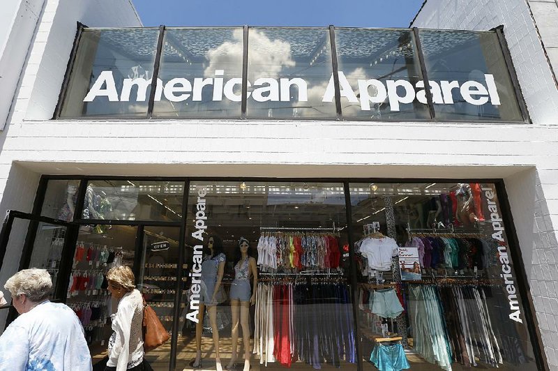 Pedestrians pass an American Apparel store in Pittsburgh in this file photo. The company fi led for bankruptcy protection on Monday. 
