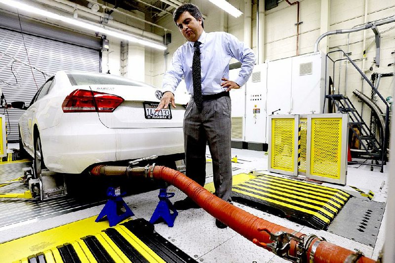 John Swanton, spokesman for the California Air Resources Board, explains how a 2013 Volkswagen Passat with a diesel engine is evaluated at an emissions test laboratory in El Monte, Calif., late last month.