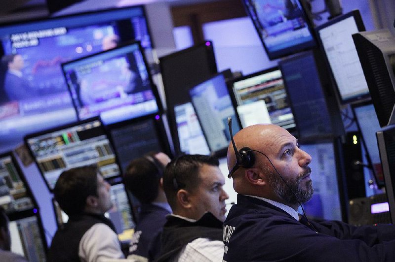 Traders work Monday at the New York Stock Exchange where indexes rose on expectation the Federal Reserve will postpone an interest rate increase.
