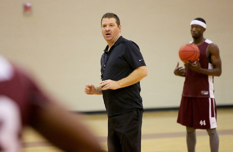 Chris Beard, UALR’s first-year men’s basketball coach, directs the Trojans during practice Tuesday.