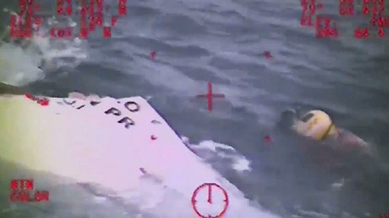 In this photo made from video and released by the U.S. Coast Guard, a Coast Guard crew member investigates a lifeboat, that was found from the missing ship El Faro. 