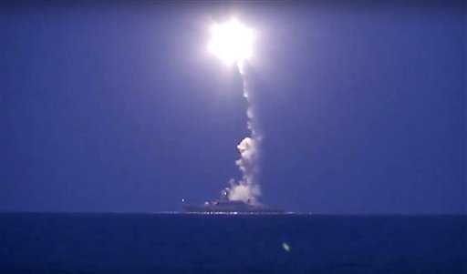In this photo made from the footage taken from Russian Defense Ministry official web site, Wednesday, Oct. 7, 2015, a Russian navy ship launches a cruise missile in the Caspian Sea. 