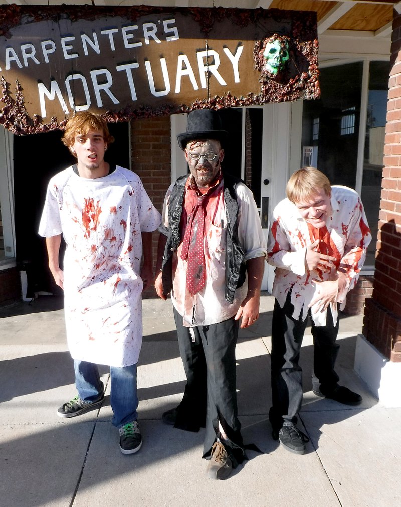 Photo by Randy Moll Three ghoulish figures were on Gentry&#8217;s Main Street before the opening of the Carpenter&#8217;s Mortuary Spook House on Friday. Dylan Peyton, Charlie Bookout and Josh Harrington were dressed up for the occasion and looking forward to entertaining guests.