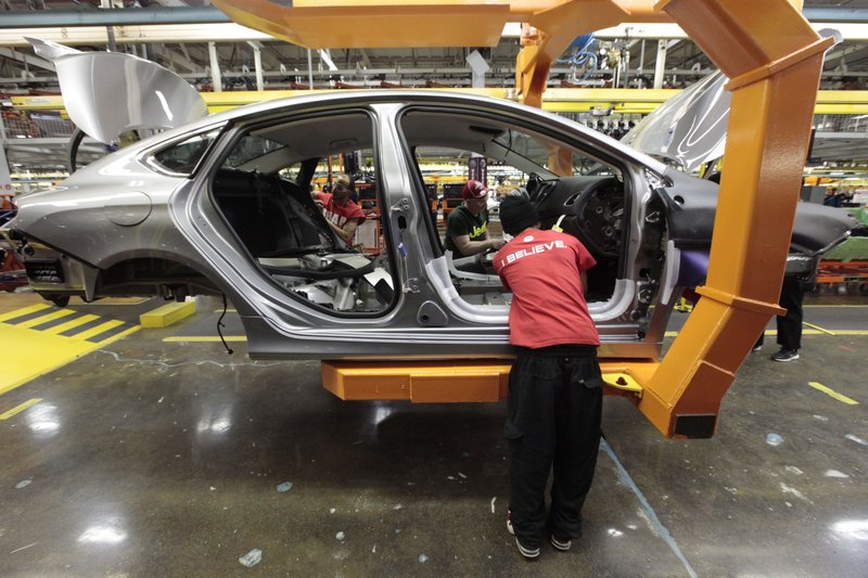 In this March 14, 2014 file photo, assembly line workers build a 2015 Chrysler 200 automobile at the Sterling Heights Assembly Plant in Sterling Heights, Mich. The United Auto Workers union is threatening to go on strike against Fiat Chrysler after its membership rejected a tentative contract deal with the company.