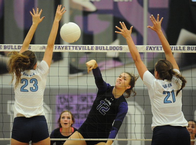 Faith Waitsman (12) of Fayetteville hits past Emily Thompson (23) and Paige Williams (21) of Springdale Har-Ber on Tuesday in Fayetteville. Visit nwadg.com/photos to see more photographs from the match.