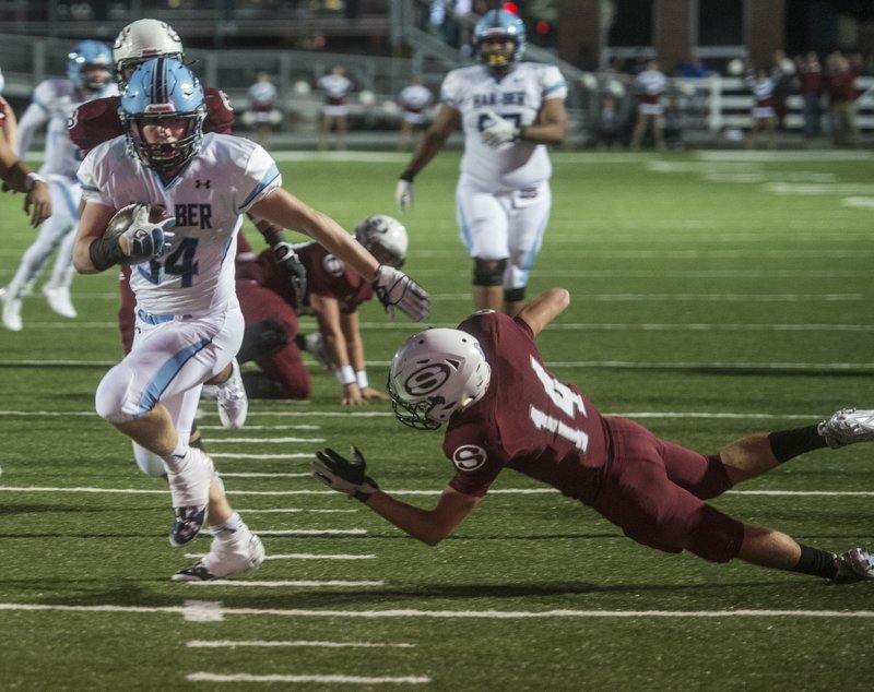 Luke Hannon, Springdale Har-Ber junior, slips past Gavin Schmidt, Springdale High senior, on his way to a touchdown Friday at Jarrell Williams Bulldog Stadium in Springdale. Hannon is the Northwest Arkansas Democrat-Gazette player of the week. To see more, visit ARPreps.com.