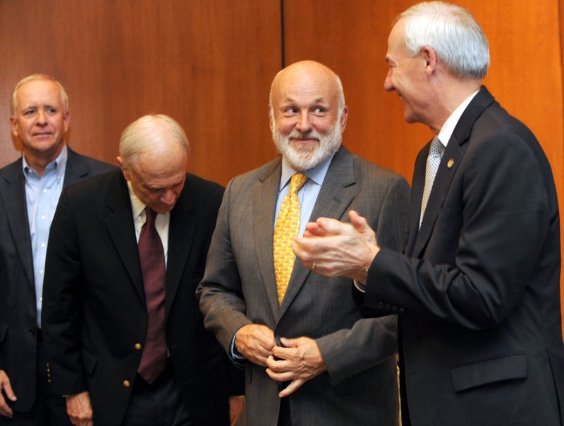 John Tyson, chairman of Tyson Foods, (center) smiles Tuesday with Gov. Asa Hutchinson (right) while standing alongside Marvin Childers, president and chief lobbyist of the Arkansas Poultry Federation, (left), and former Sen. David Pryor during a celebration for the Center for Excellence for Poultry Science’s 20th anniversary and to announce a $1.3 million gift from Tyson Foods on the University of Arkansas campus in Fayetteville. 