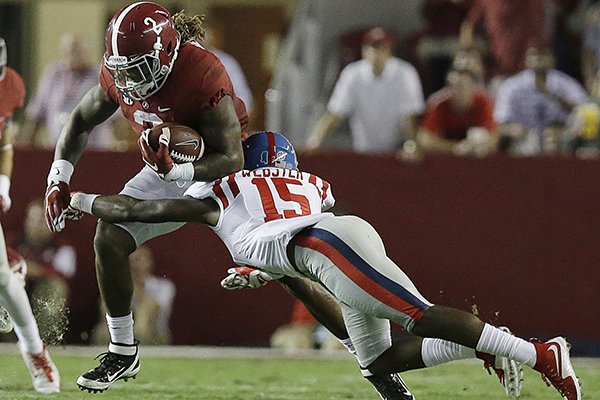 Alabama running back Derrick Henry (2) is tackled by Mississippi defensive back Kendarius Webster (15) during first half of an NCAA college football game, Saturday, Sept. 19, 2015, in Tuscaloosa, Ala. (AP Photo/Brynn Anderson)