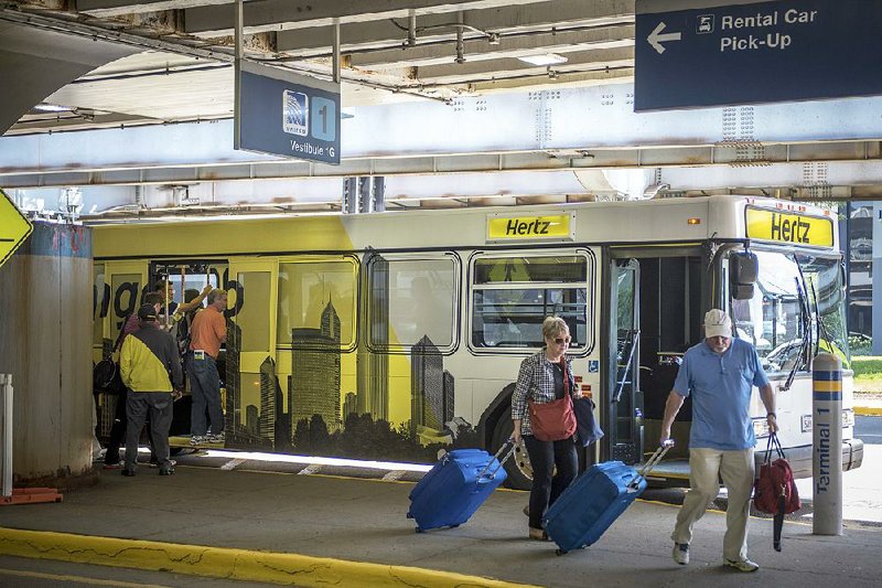 A Hertz shuttle bus picks up and drops off travelers at O’Hare International Airport in Chicago in August. Chicago recently sold $2 billion in bonds to refinance older airport debt and for terminal improvements at O’Hare. 