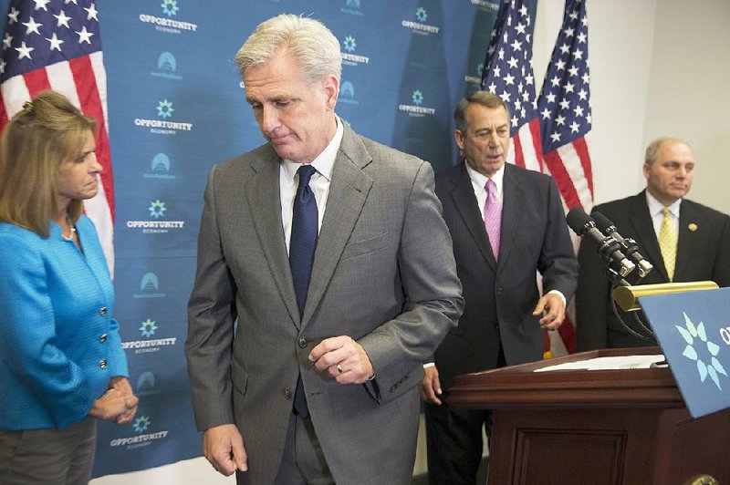 House Majority Leader Kevin McCarthy leaves after speaking at a Capitol Hill news conference held Wednesday after the House Republican caucus meeting with Speaker John Boehner (second from right). 