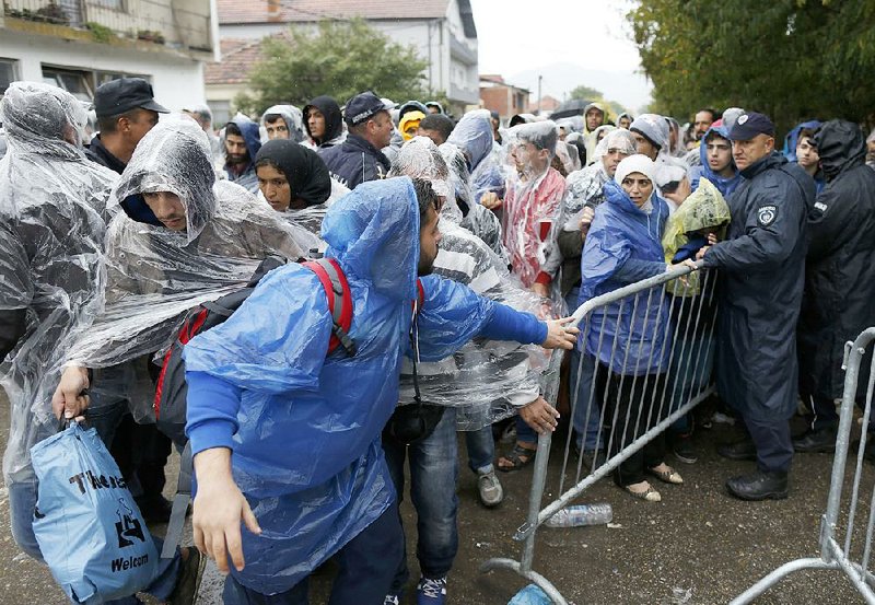 Migrants line up to register with the police Wednesday at a refugee center in the southern Serbian town of Presevo. 
