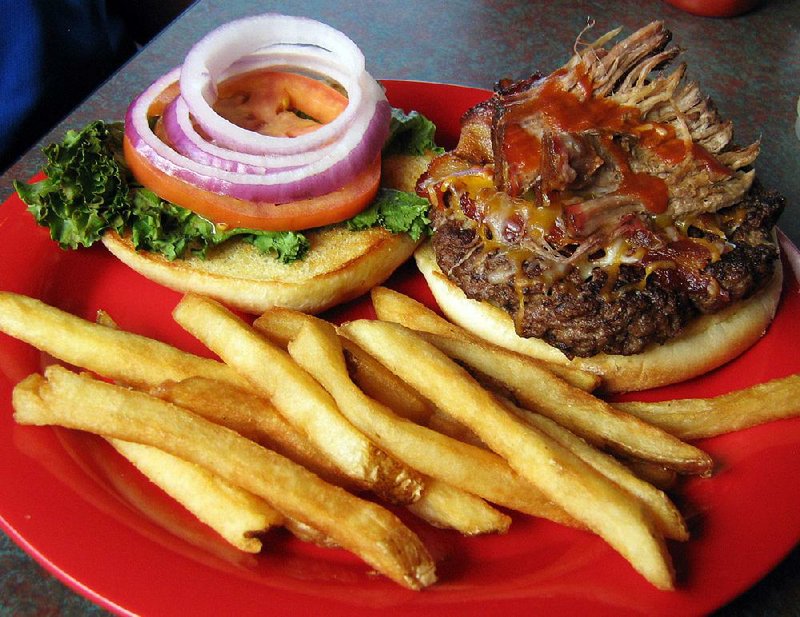 The #WPS burger at Nashville Rockin’ Grill in North Little Rock is topped with pulled pork, cheese, bacon, lettuce, onion and tomato and comes with fries. 