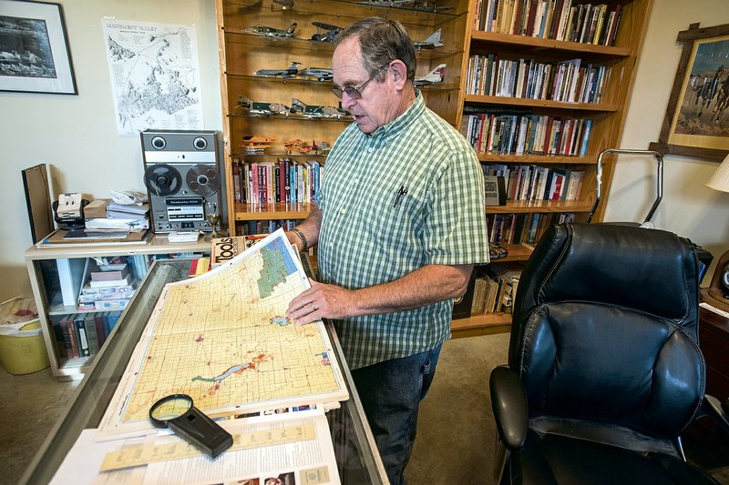 James Crownover looks over some maps in his Elm Springs writing shop, meticulously researching the settings and stories for his Western novels. Crownover won two coveted Spur awards from the Western Writers of America for the best first Western historical novel and the best first novel: Wild Ran the Rivers. 