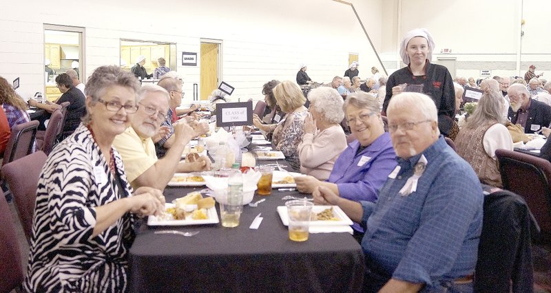 RITA GREENE MCDONALD COUNTY PRESS Shirley Morgan Alps, left, and David Alumbaugh, and a host of other people, enjoying a great meal at the Pineville Reunion on Saturday.