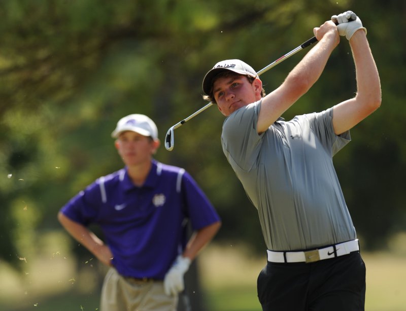 NWA Democrat-Gazette/ANDY SHUPE Luke Long (right) of Fayetteville watches his tee shot Wednesday on No. 9 as Mitchell Ford of Little Rock Catholic watches while participating in the boys Class 7A State Golf Championship at Fayetteville Country Club. Visit nwadg.com/photos to see more from the championship match.