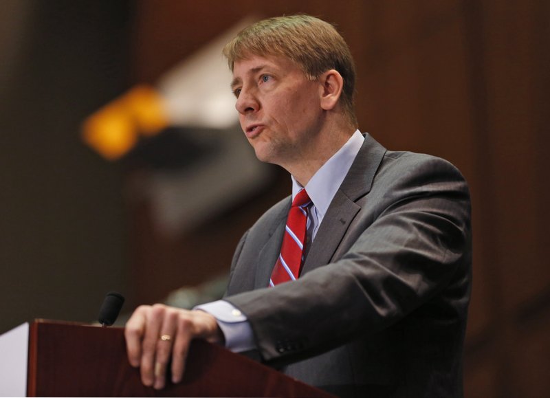 In this March 26, 2015, file photo, Consumer Financial Protection Bureau (CFPB) Director, Richard Cordray, speaks during a panel discussion in Richmond, Va. The CFPB is considering banning a practice known as forced arbitration for financial services.