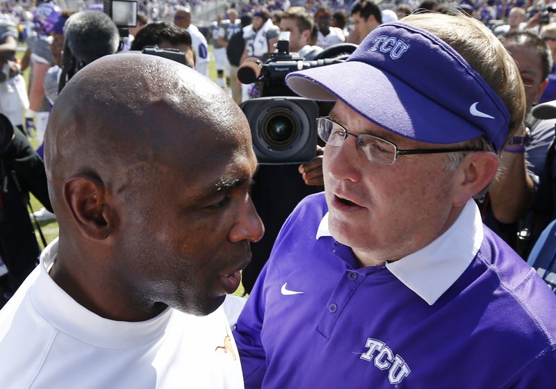 Texas head coach Charlie Strong, left, meets with TCU head coach Gary Patterson, right, after TCU defeated Texas 50-7 in an NCAA football game Saturday, Oct. 3, 2015, in Fort Worth, Texas.