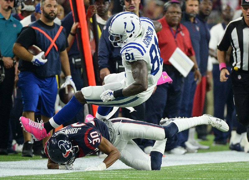  Indianapolis wide receiver Andre Johnson (81) is taken down by Houston defensive back Kevin Johnson during Thursday night’s game at Reliant Stadium in Houston. Johnson caught two touchdown passes to help the Colts beat his former team for the sixth consecutive time.