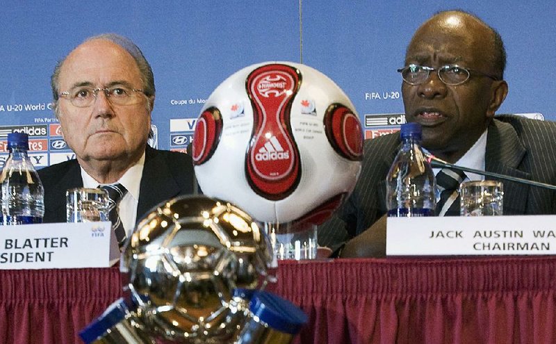  In this July 20, 2007 file photo Joseph "Sepp" Blatter, left, president of FIFA, listens to Jack Warner, chairman of the tournament, during a news conference as part of the FIFA U-20 World Cup in Toronto, Canada. 