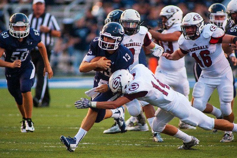 Greenwood quarterback Connor Noland (13) runs for a first down during a game againt Springdale last month. Noland, a sophomore, and fellow quarterback Luke Hakes have led Greenwood to a 5-0 record, 2-0 in the 7A/6A-Central.