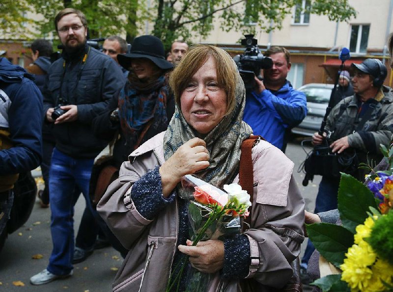Belarusian journalist and writer Svetlana Alexievich the 2015 Nobel literature winner is surrounded as she leaves a news conference in Minsk, Belarus, Thursday, Oct. 8, 2015. Belarusian writer Svetlana Alexievich won the Nobel Prize in literature Thursday, for works that the prize judges called "a monument to suffering and courage." 