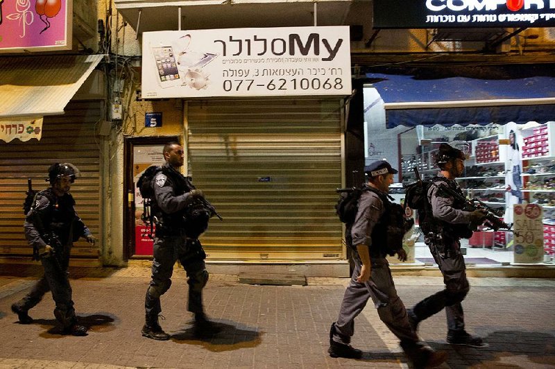 Israeli police patrol near the site where an Israeli soldier was stabbed Thursday in the northern city of Afula.
