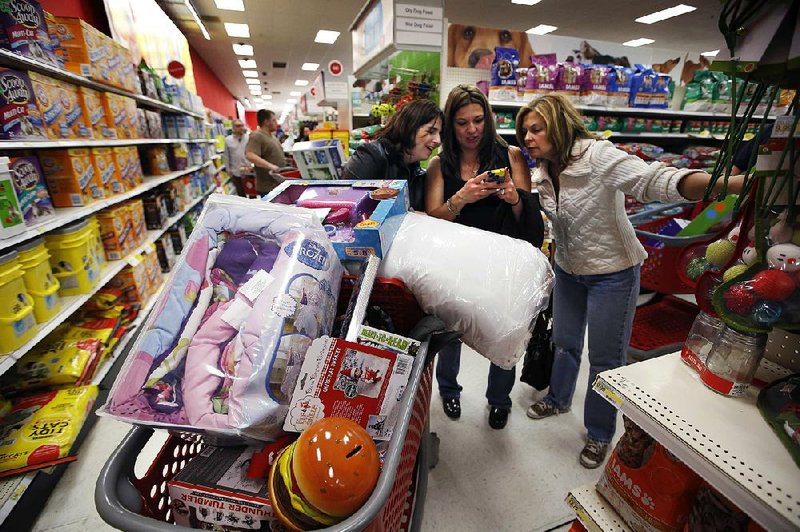 Shoppers huddle at a Target store in South Portland, Maine, on Nov. 28. The National Retail Federation said Christmas spending will rise 3.7 percent this year.