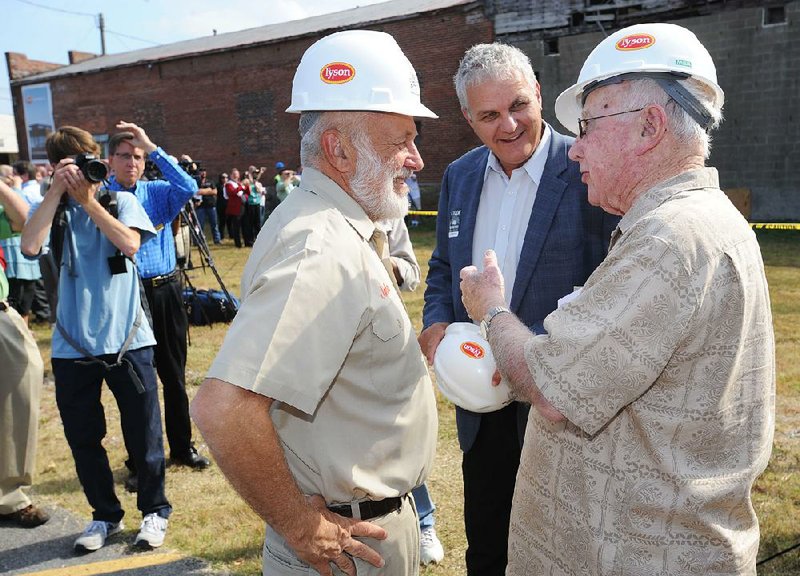 John Tyson, chairman of Tyson Foods Inc., (from left) and Springdale Mayor Doug Sprouse talk with businessman Walter Turnbow on Thursday in Springdale.