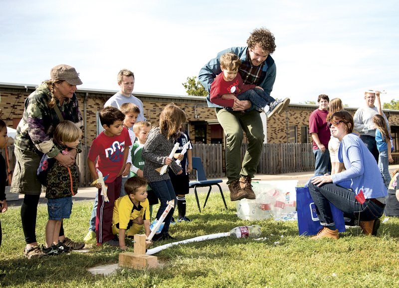 A man and boy launch a stomp rocket at last year's Tinkerfest.