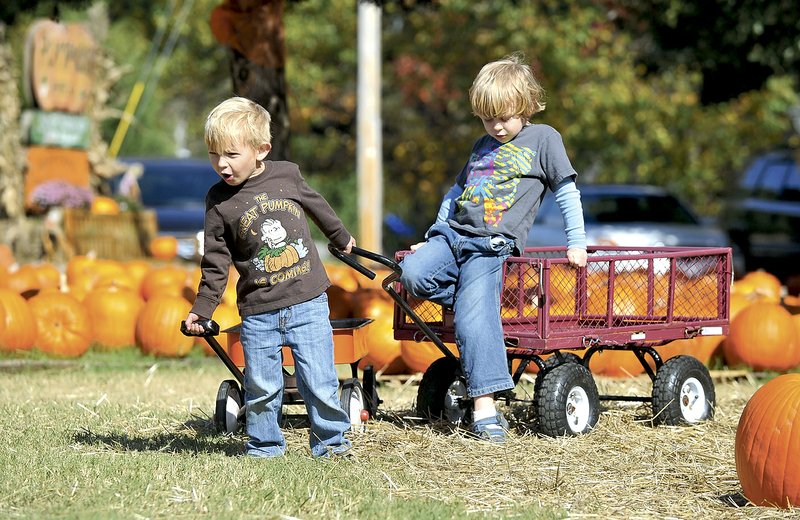 Parker Ganio and Xander Sprankell play last year at a pumpkin patch in Fayetteville. Pumpkin patches, haunted houses and ghostly tours are open around the region this weekend and throughout the month.