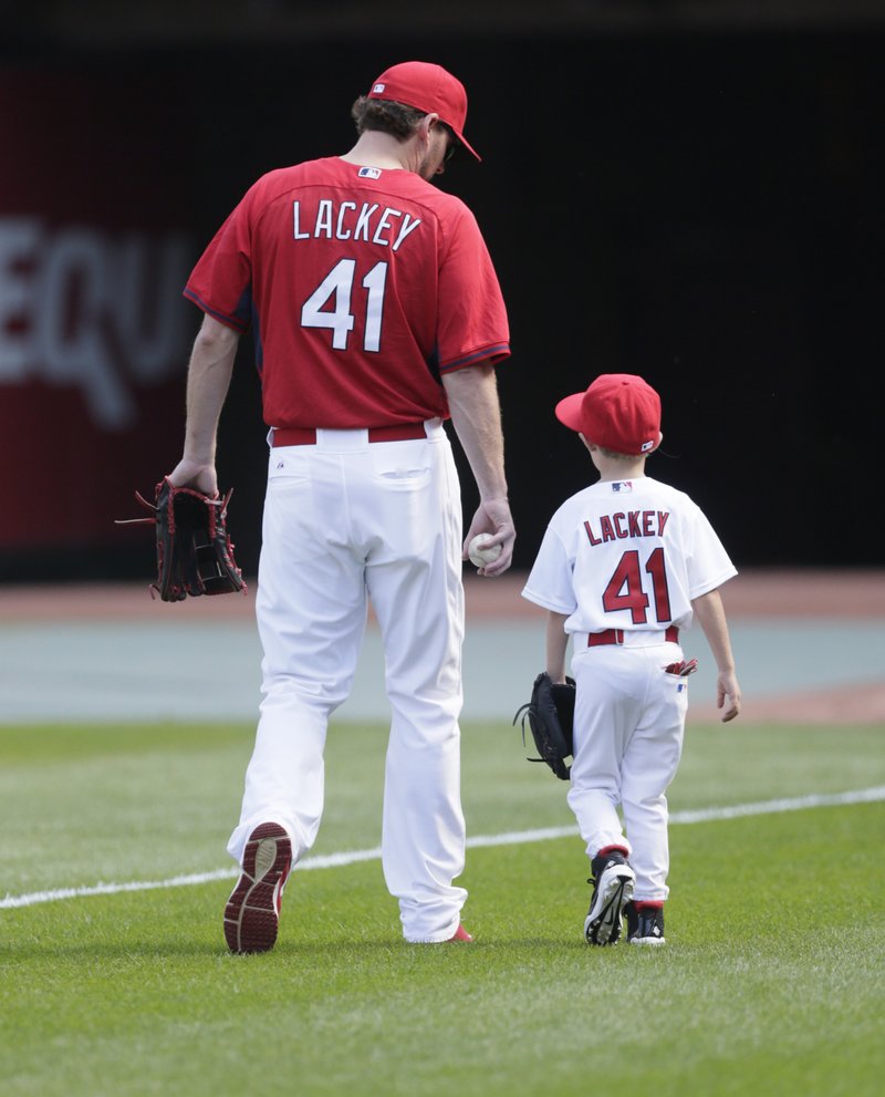 St. Louis Cardinals Game 1 starter John Lackey walks to the bull pen with his six-year-old son, Carter, during the team workout, Thursday, Oct. 8, 2015 in St. Louis. 