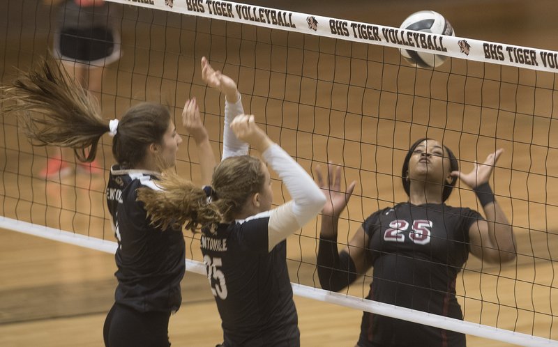 Springdale High's Desiree Mack (25) tries to get control of the ball Thursday after her kill was blocked by Bentonville's Kathryn Charlson (25) and Sadie Pate in Bentonville. For more photos go to nwadg.com/photos.