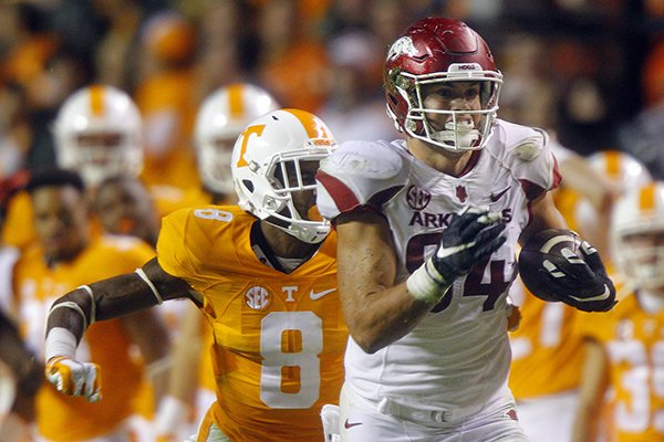 Arkansas tight end Hunter Henry (84) outruns Tennessee defensive back Justin Martin (8) during the second half of an NCAA college football game Saturday, Oct. 3, 2015 in Knoxville, Tenn. Arkansas won 24-20(AP Photo/Wade Payne)