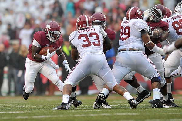 Arkansas running back Alex Collins carries the ball during a game against Alabama on Saturday, Oct. 12, 2014, at Razorback Stadium in Fayetteville. 