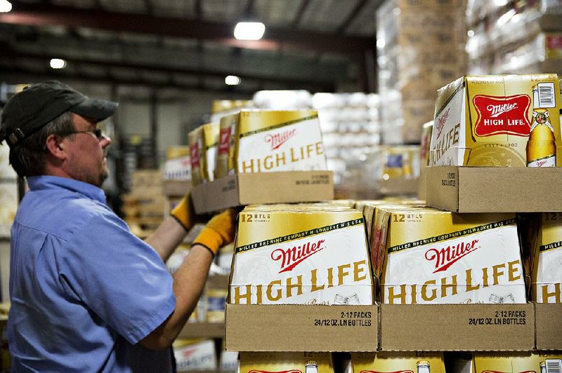A worker stacks Miller beer in a Peoria, Ill., warehouse in September. In its takeover attempt of SABMiller, the maker of Miller beer, Anheuser-Busch InBev said it wants to create “the first truly global beer company.”

