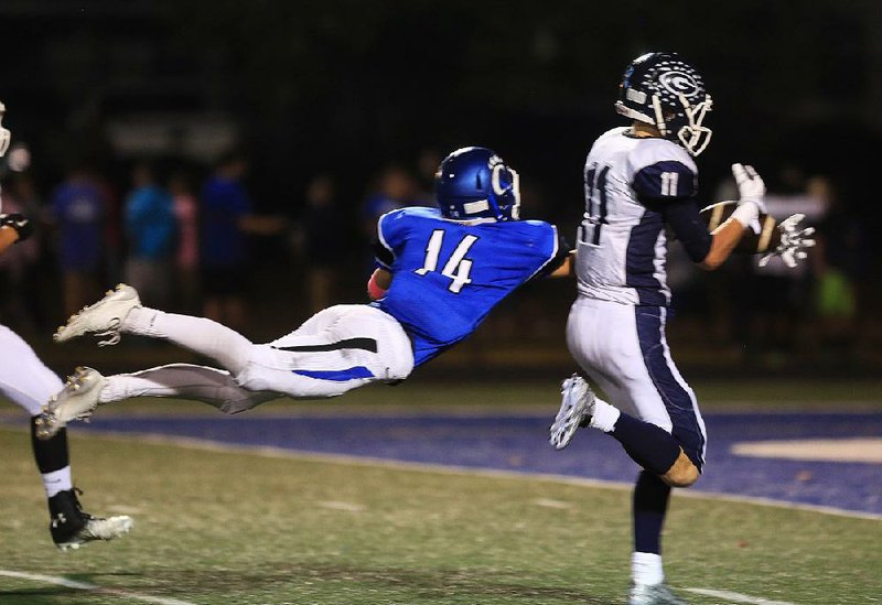 Greenwood’s Jax Burgess (11) intercepts a pass intended for Conway’s Brayden Leach (14) during Friday night’s game in Conway.