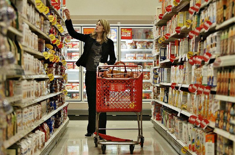 A shopper browses the aisle in the grocery section of a Target store in Columbus, Ohio, in this file photo. In delaying its grocery overhaul, Target said it needs more time “to get it right.” 