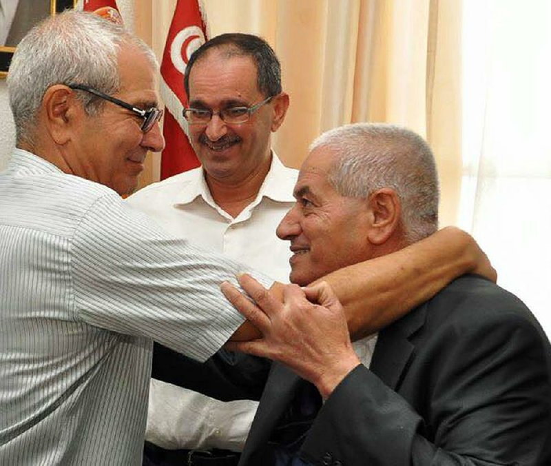 Houcine Abassi, (right) leader of the Tunisian General Labor Union, is congratulated Friday in his office in Tunis. He said he was “overwhelmed.”
