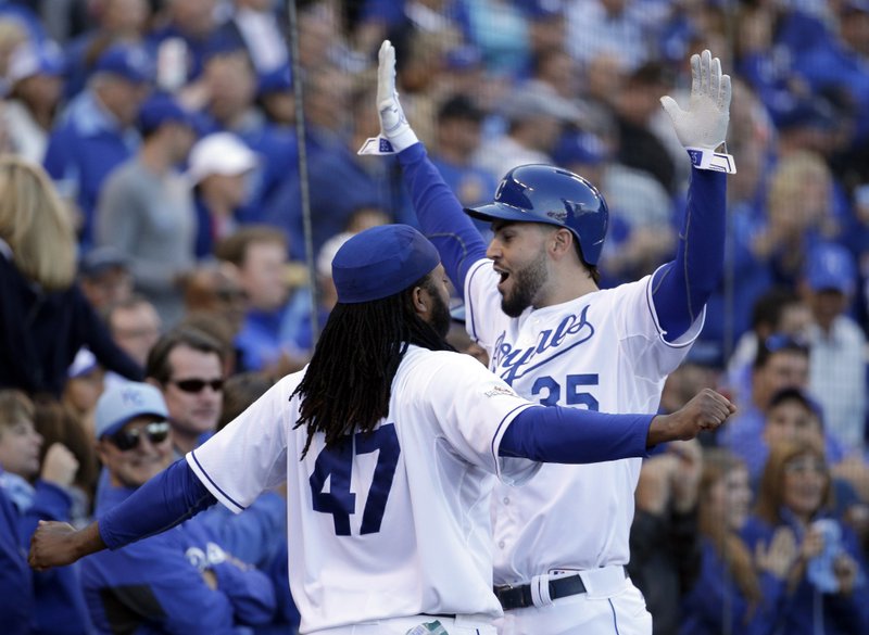 Kansas City Royals' Eric Hosmer, right, celebrates with Johnny Cueto (47) after scoring a run following a walk by teammate Salvador Perez during the sixth inning of Game 2 in baseball's American League Division Series against the Houston Astros, Friday, Oct. 9, 2015, in Kansas City, Mo.