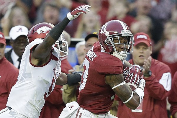 Alabama wide receiver ArDarius Stewart (13) runs the ball before being tackled by Arkansas defensive back Henre' Toliver (5) in the first half of an NCAA college football game, Saturday, Oct. 10, 2015, in Tuscaloosa, Ala. (AP Photo/Brynn Anderson)
