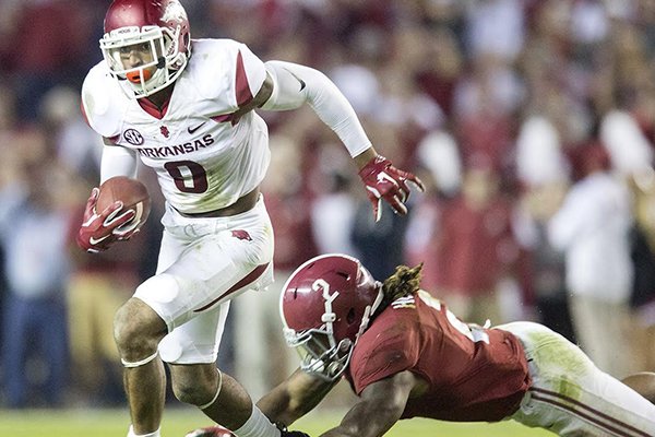 Arkansas defensive back Santos Ramirez (9) slips away from Alabama running back Derrick Henry (2) after intercepting a pass in the second quarter on Saturday, Oct. 10, 2015, at Bryant-Denny Stadium in Tuscaloosa, Ala.