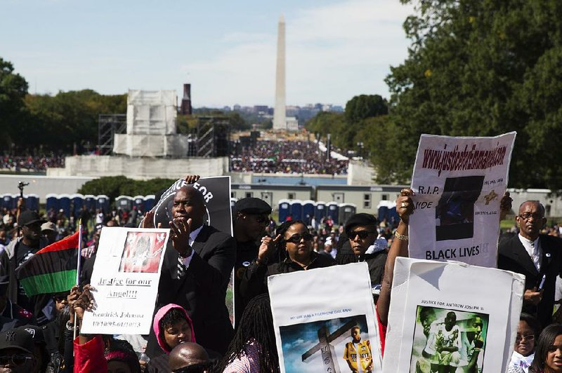 People cheer Saturday during a rally in Washington to mark the 20th anniversary of the Million Man March.
