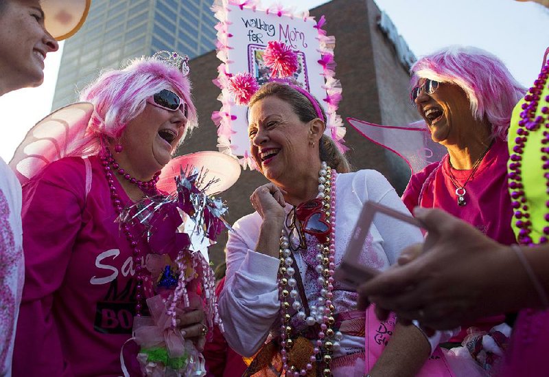 Allison Nicholson (from left), Carla Robertson, Darla Harb and Tracy Garstka, all friends with Team Mello Velo, wait Saturday for the beginning of the 2K event at the Susan G. Komen Race for the Cure in Little Rock. The group raced in honor of friend Nancy Holstead, a breast cancer survivor. 