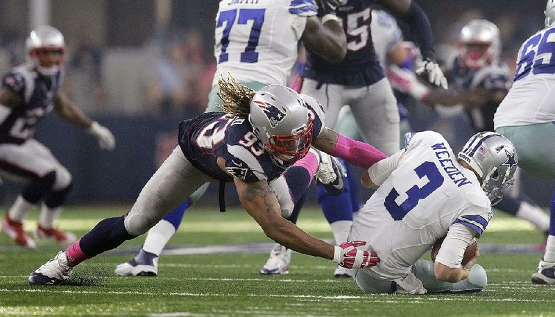 New England defensive end Jabal Sheard (93) sacks Dallas quarterback Brandon Weeden in the second quarter of Sunday’s game at AT&T Stadium in Arlington, Texas. The Patriots pulled away and beat the Cowboys 30-6 to remain unbeaten and extend their winning streak to seven games dating back to last year.