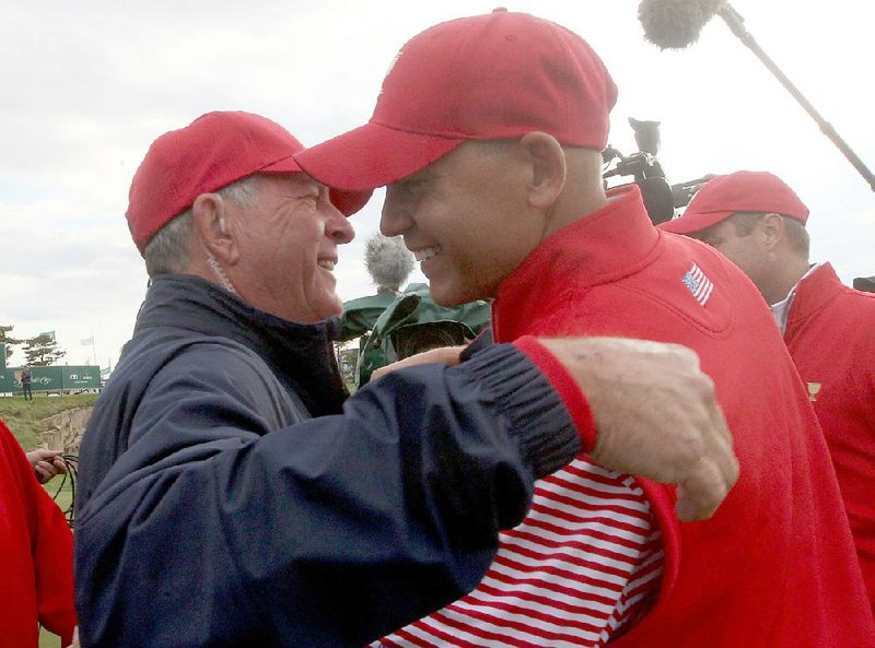 U.S. captain Jay Haas (left) hugs his son Bill after Bill beat Korea’s Sang-moon Bae to provide the winning point for the Americans, who beat the International team 151/2-141/2 to capture the Presidents Cup for the sixth consecutive time.