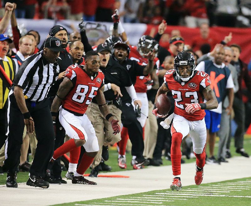 Atlanta Falcons cornerback Robert Alford heads for the end zone after intercepting a pass intended for Washington Redskins receiver Ryan Grant during overtime Sunday in Atlanta.